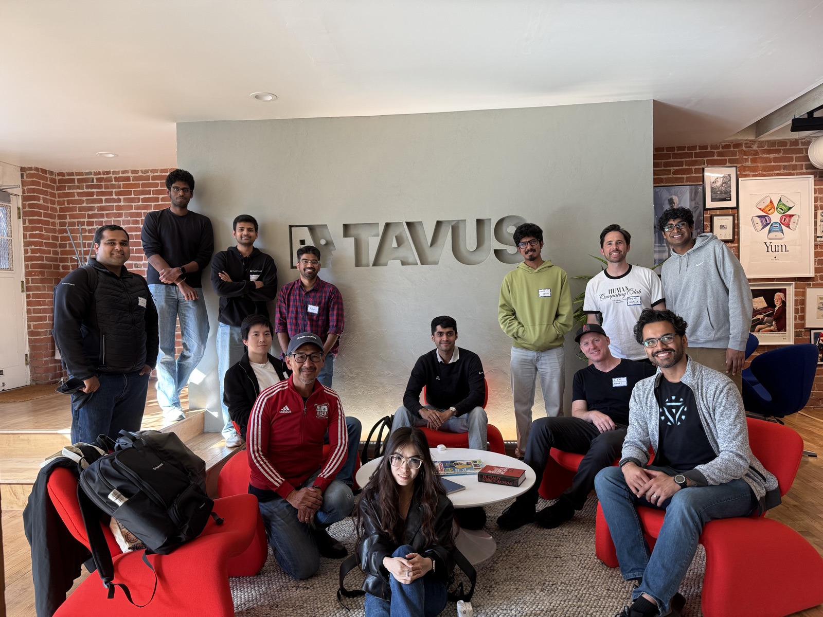 The judges and organizing team in front of the Tavus sign